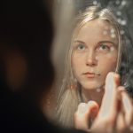 woman looking in the mirror